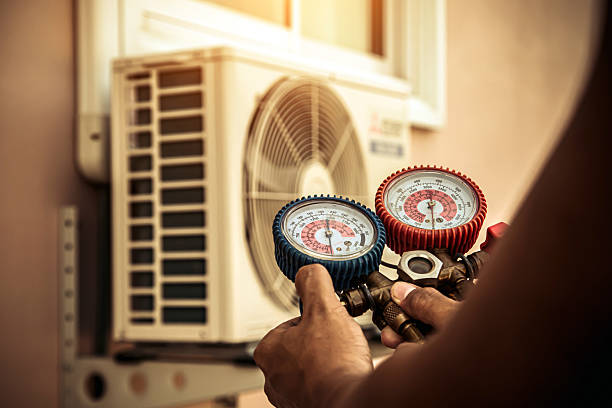 Professional Air Conditioning Service technician working in Camden, MO